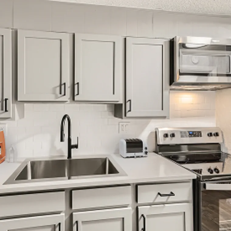Lost Creek Apartments kitchen with white cabinetry and stainless steel appliances
